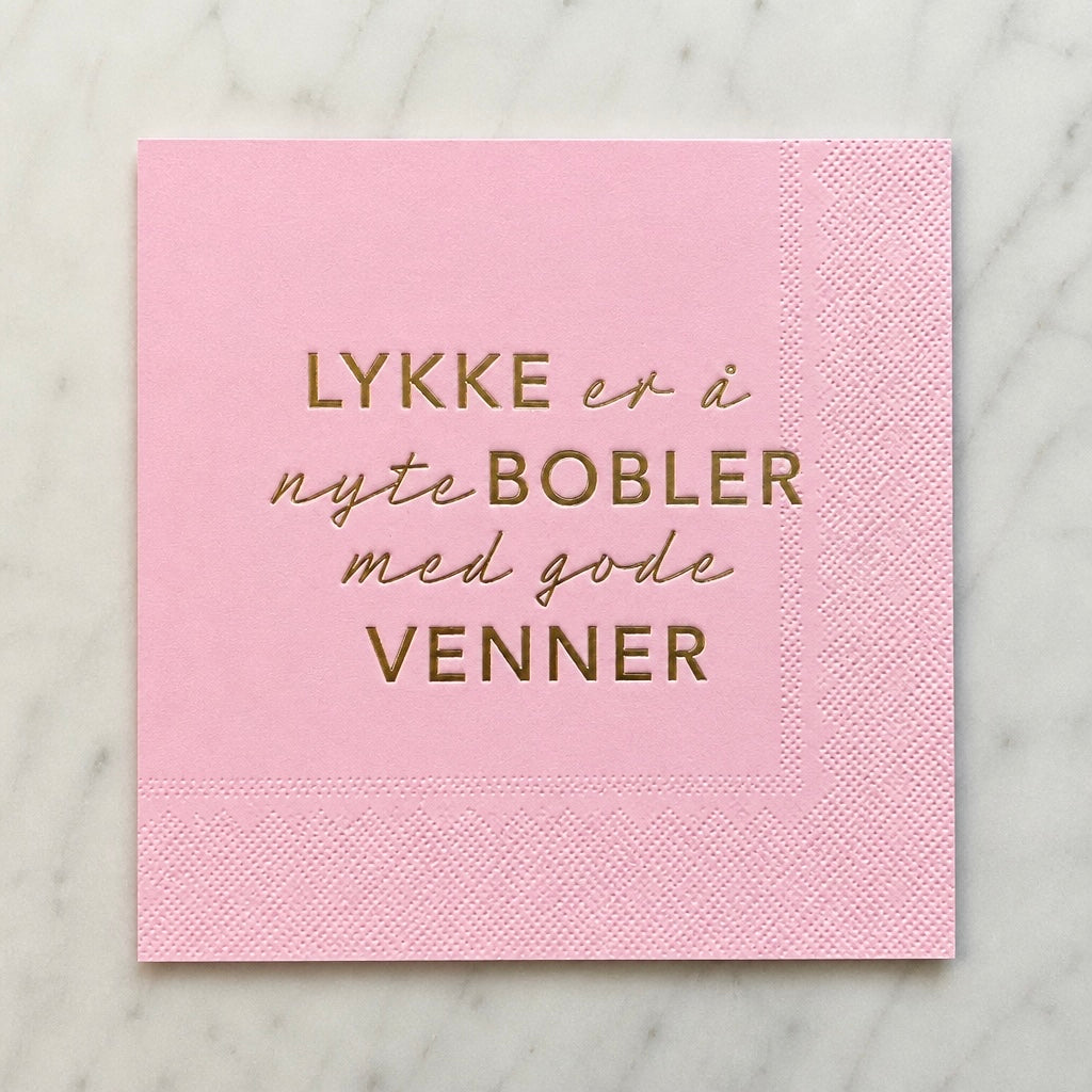 3-lags rosa serviett med gull tekst - Lykke er å nyte bobler med gode venner.