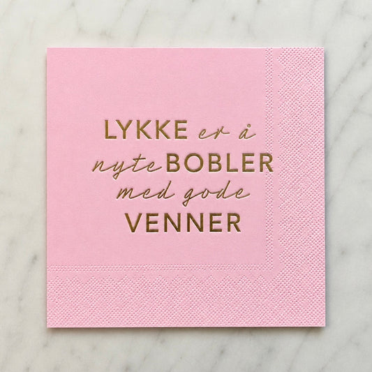 3-lags rosa serviett med gull tekst - Lykke er å nyte bobler med gode venner.